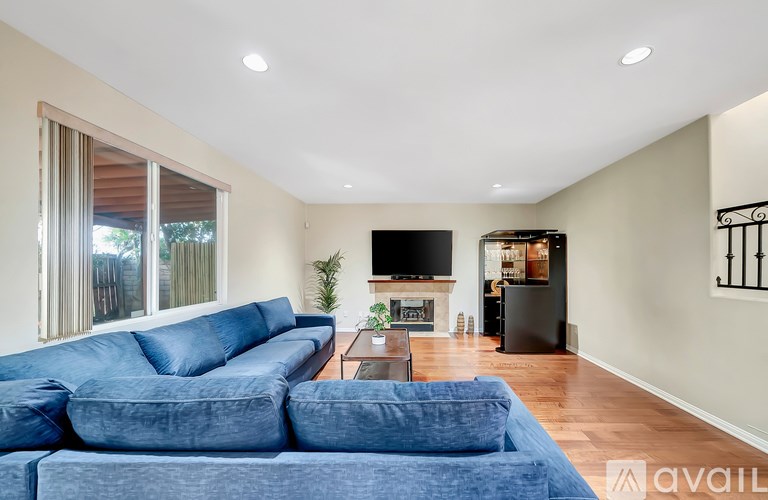 A living room with a blue couch and a television.