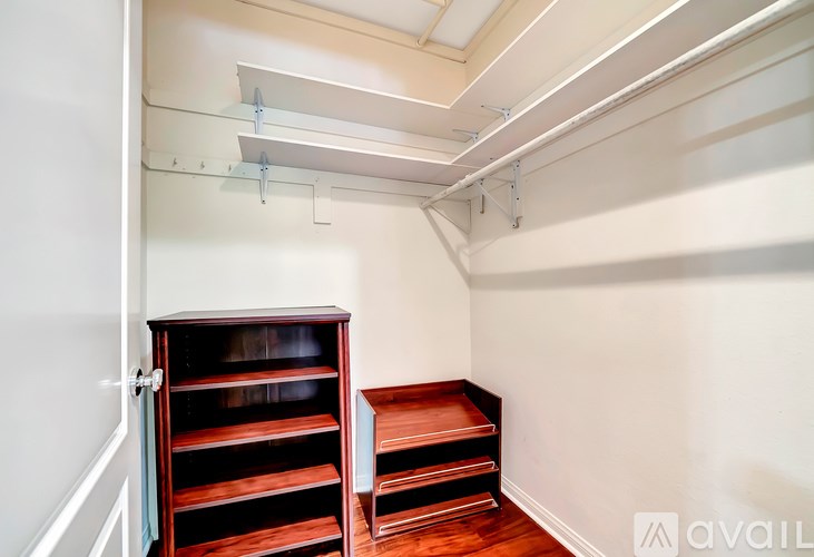 A room with a wooden shelf and a white wall.
