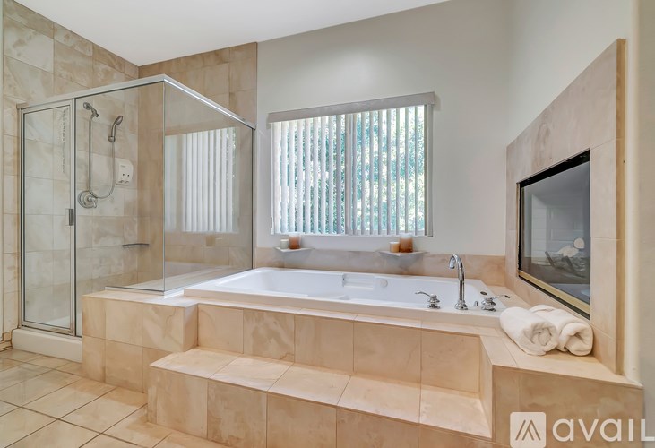 A bathroom with a large tub and a walk-in shower.