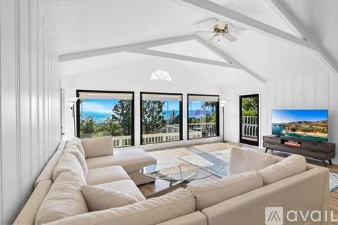 A living room with a large couch and a flat screen TV.