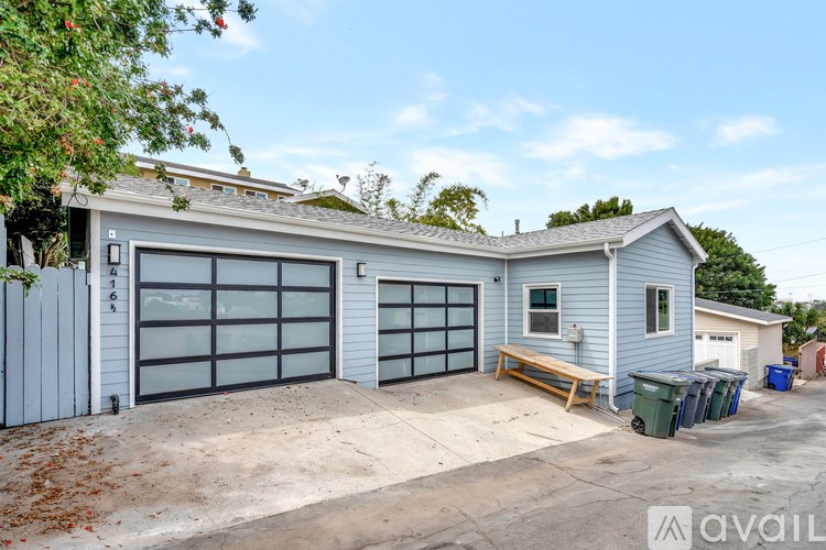 A two-car garage is attached to a small house.
