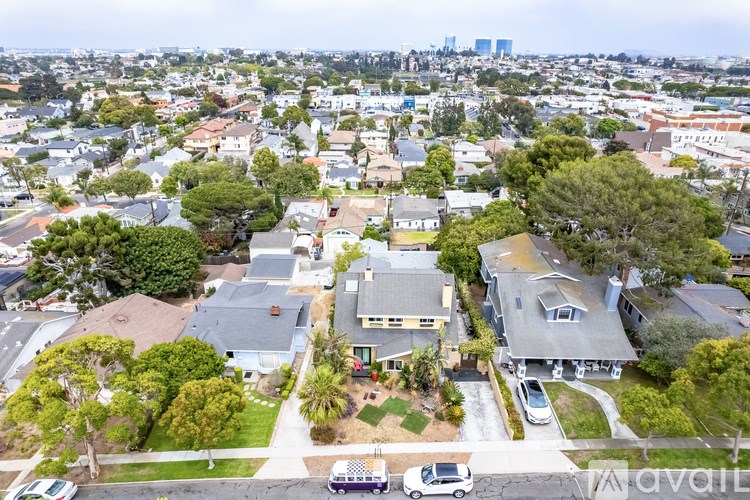 A bird's eye view of a residential area with houses and cars.