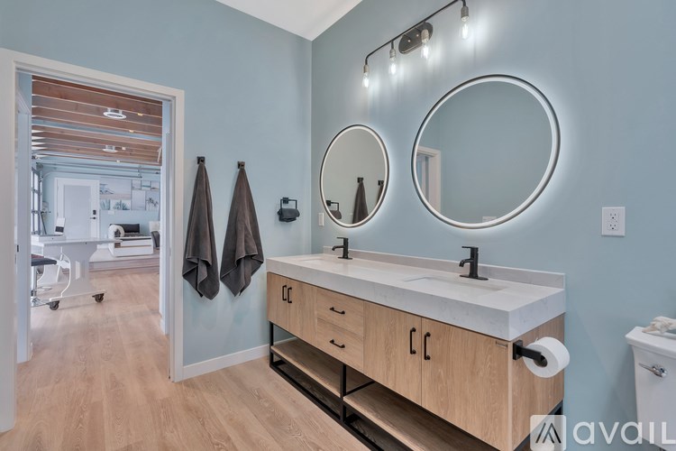 A bathroom with a mirror and lights above it.