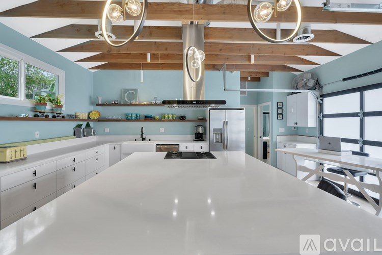 A modern kitchen with a large island in the center.