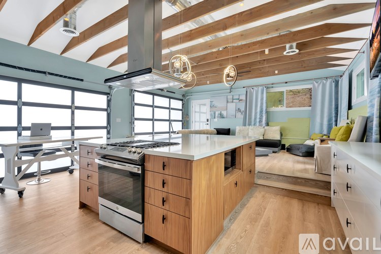 A modern kitchen with wooden cabinets and stainless steel appliances.