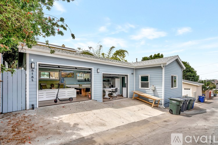 A two-story house with a garage and a driveway.
