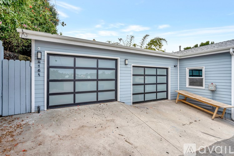 A two-car garage with a bench outside.