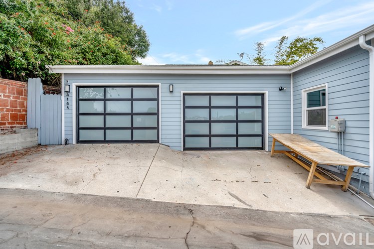 A two-car garage with a bench in front.