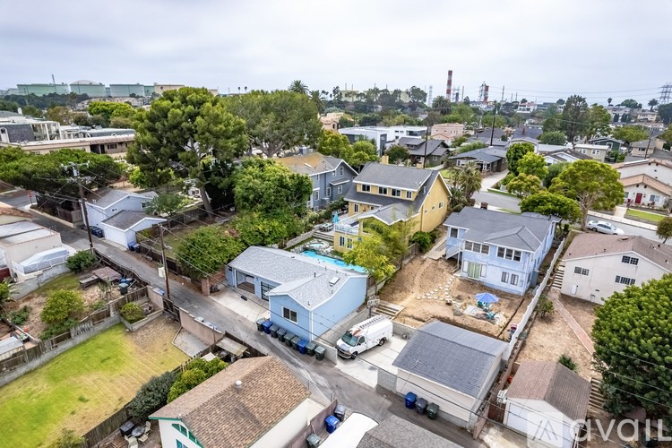 A bird's eye view of a residential area with houses and cars.