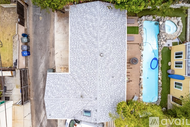 A modern house with a pool and a small garden.