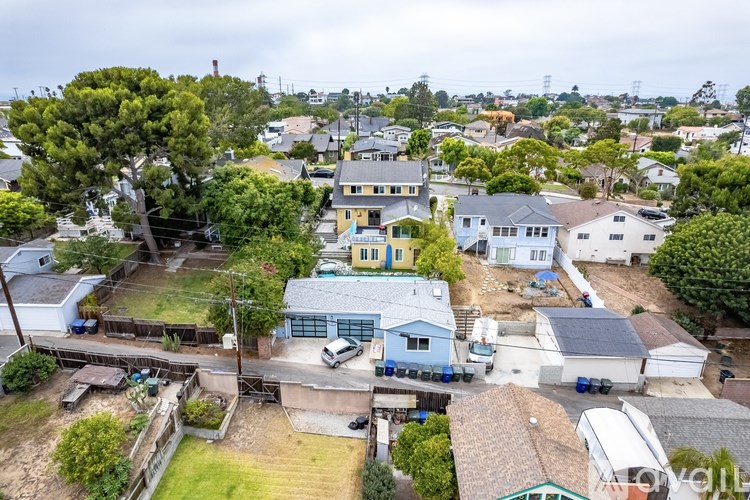 A bird's eye view of a residential area with houses and cars.