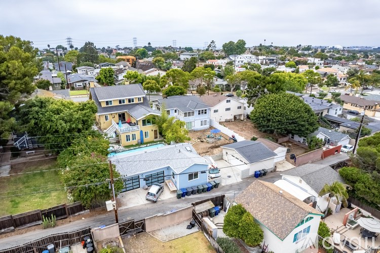 A bird's eye view of a residential area with houses and cars.