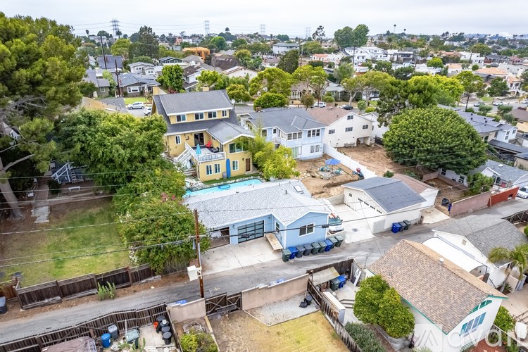 A bird's eye view of a residential area with houses and trees.