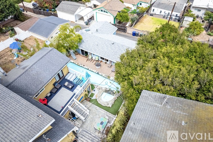 A bird's eye view of a residential area with houses and trees.