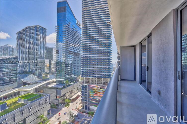 A modern cityscape with tall buildings and a balcony overlooking the city.