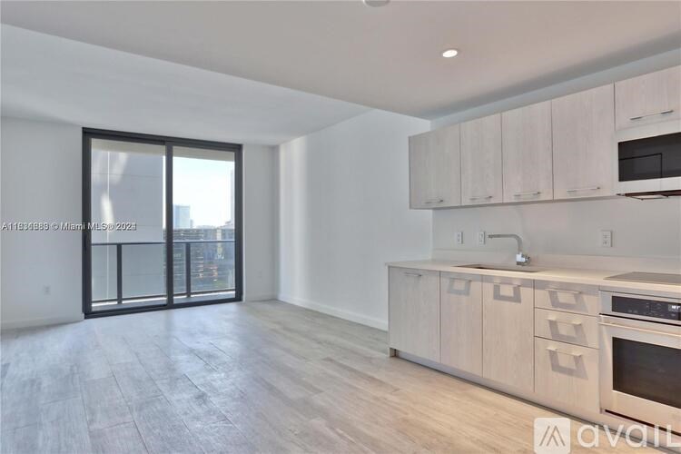 A kitchen with wooden floors and cabinets is available for rent.