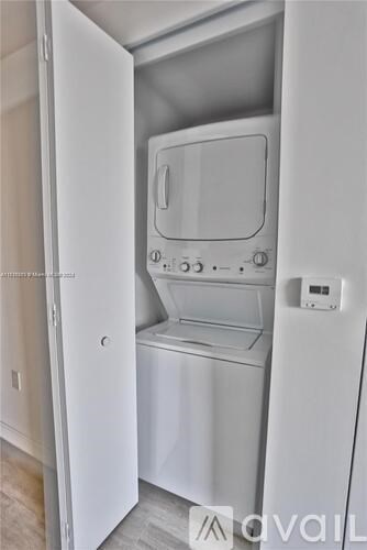 A white washing machine and dryer in a small laundry room.
