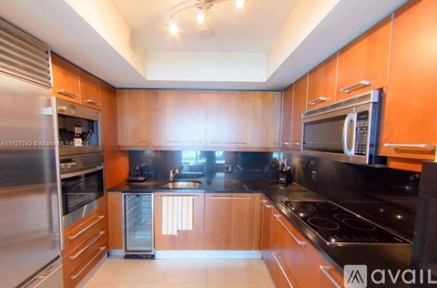 A kitchen with wooden cabinets and stainless steel appliances.