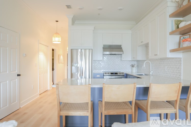 A kitchen with a table and chairs.