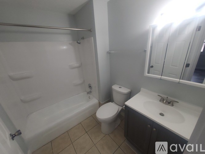A bathroom with a toilet, sink, and bathtub.