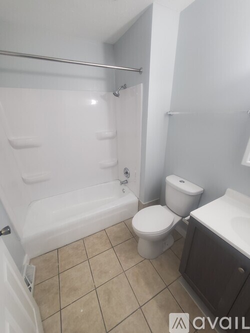 A bathroom with a toilet, sink, and bathtub.