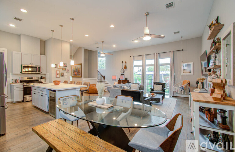 A modern kitchen with a glass table and chairs.