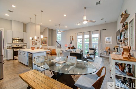 A modern kitchen with a glass table and chairs.