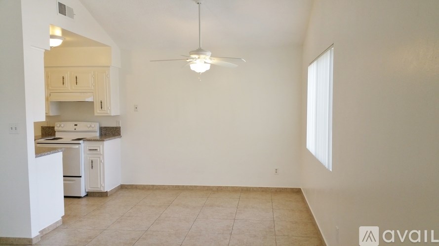 A kitchen with white appliances and cabinets is available for rent.