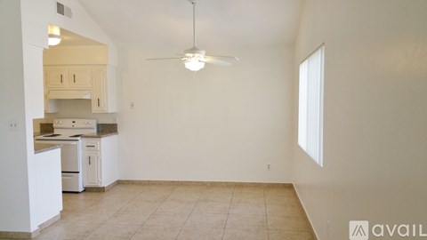 A kitchen with white appliances and cabinets is available for rent.