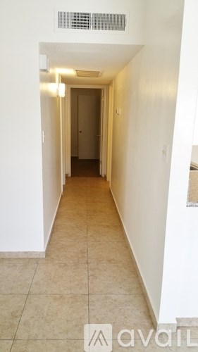 A long hallway with a door at the end.
