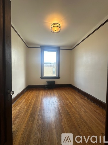 A room with wooden floors and a window.
