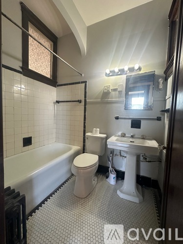 A bathroom with a white toilet, sink, and bathtub.