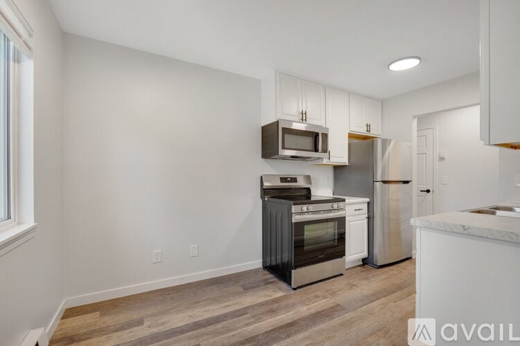 A kitchen with white cabinets and stainless steel appliances.