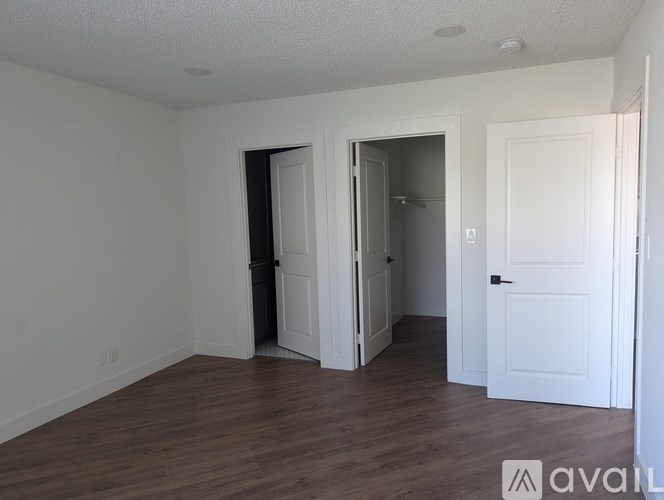 A room with a white door and a white wall.
