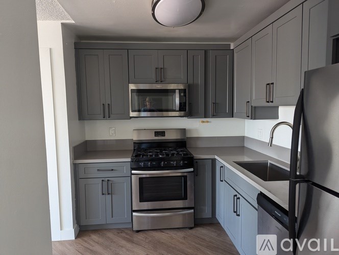 A kitchen with a stove, oven, and microwave.