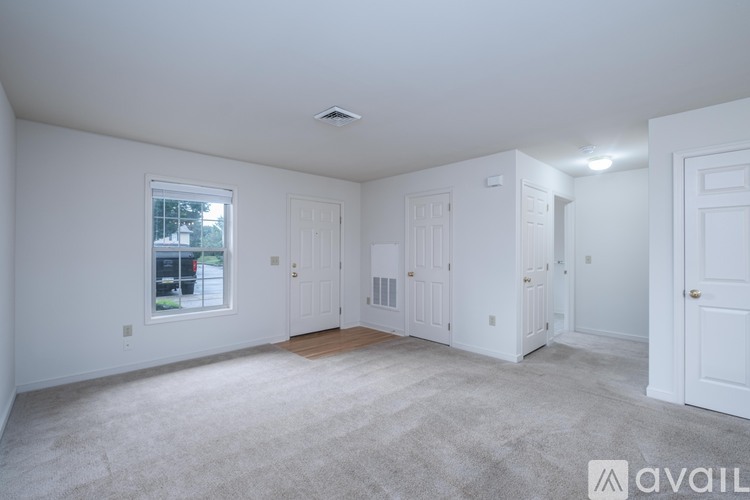 A sunny room with a large window and a door.