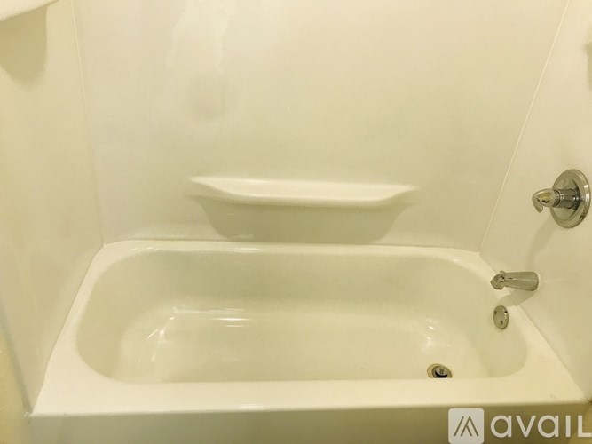A white bathroom sink with a white bowl on top of it.