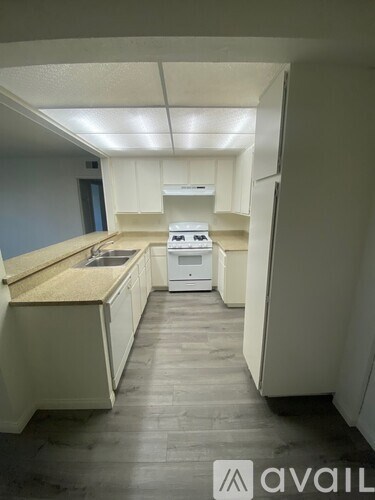 A kitchen with white cabinets and a countertop.
