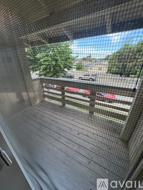 A view from inside a vehicle looking out through a mesh window.