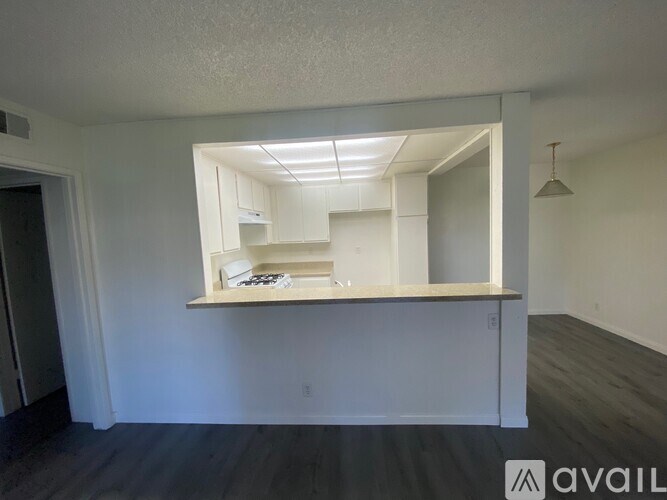 A room with a mirrored wall and a wooden floor.