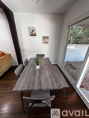 A modern dining room with a wooden table and chairs.