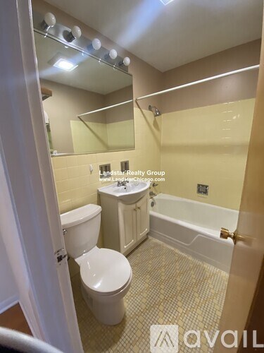 A bathroom with a toilet, sink, and bathtub.