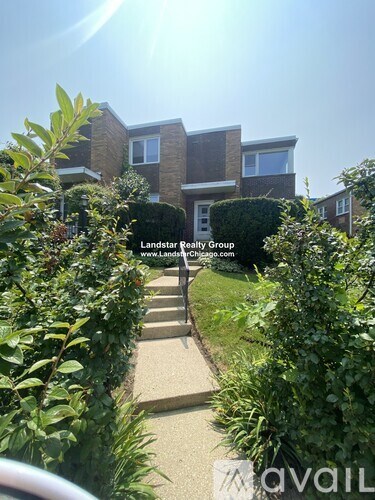 A residential area with a house and a sign for Landstar Realty Group.