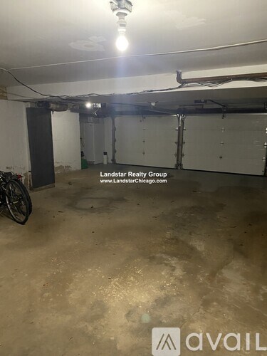 A large, empty garage with a bicycle parked in the corner.