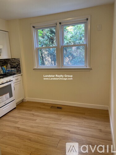 A kitchen with a window showing trees outside.
