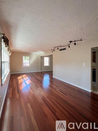 A room with wooden floors and white walls.