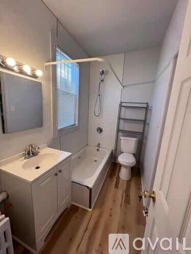 A bathroom with a white sink, toilet, and bathtub.