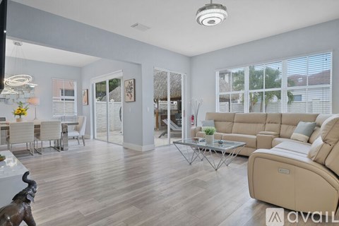 A living room with a glass coffee table and a sofa.