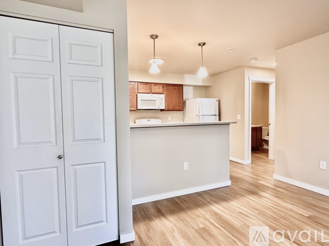 A kitchen with white cabinets and a white fridge.