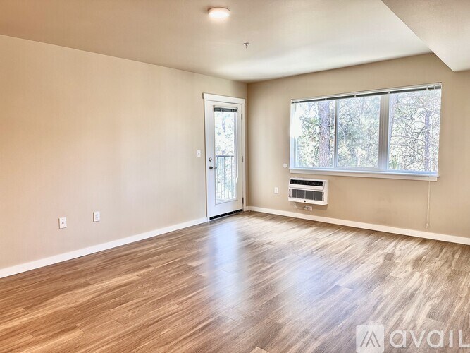 A bathroom with a sink, toilet, and mirror.